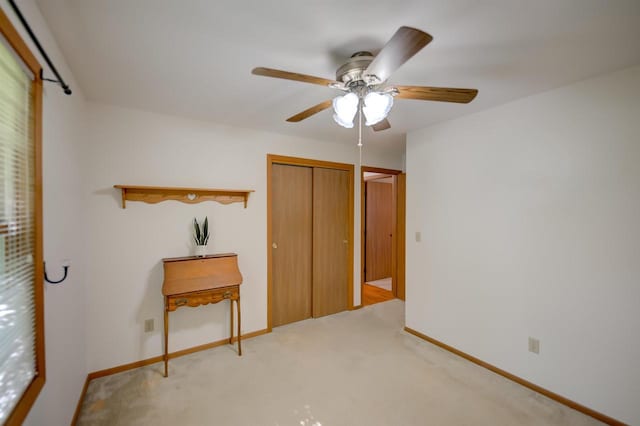851 Hennessy St, Oshkosh, WI 54904 - unfurnished bedroom featuring light carpet, a closet, and a ceiling fan