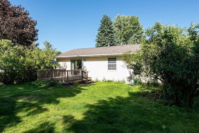 851 Hennessy St, Oshkosh, WI 54904 - rear view of house with a yard and a wooden deck