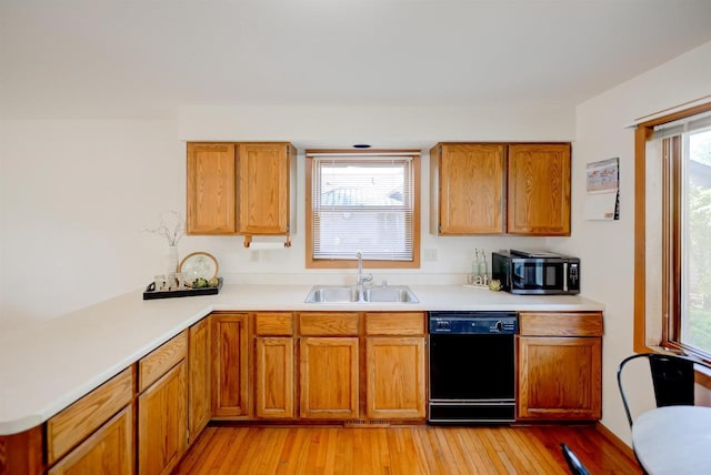 851 Hennessy St, Oshkosh, WI 54904 - kitchen with black appliances, light countertops, and light wood-style floors
