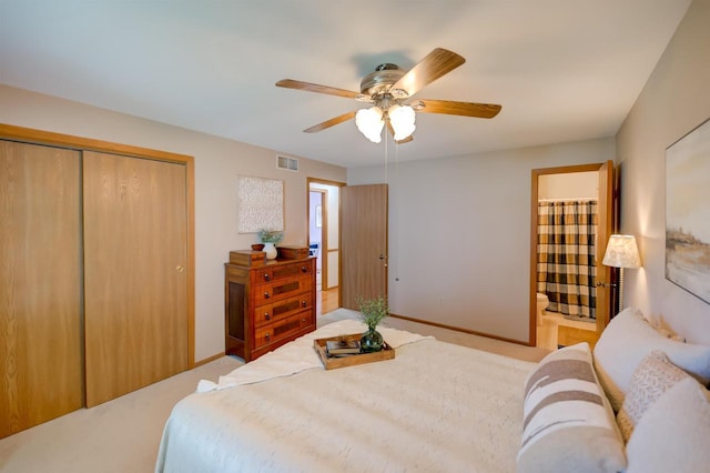 851 Hennessy St, Oshkosh, WI 54904 - bedroom featuring a closet, ceiling fan, light colored carpet, and connected bathroom