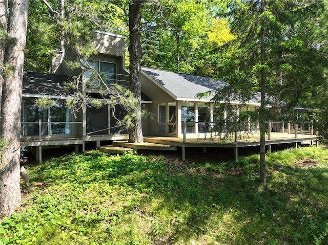 8674 Nor Wis Rd, Hayward, WI 54843 - back of property with a sunroom and a deck
