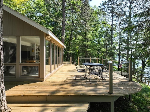 8674 Nor Wis Rd, Hayward, WI 54843 - wooden terrace featuring outdoor dining area and a sunroom