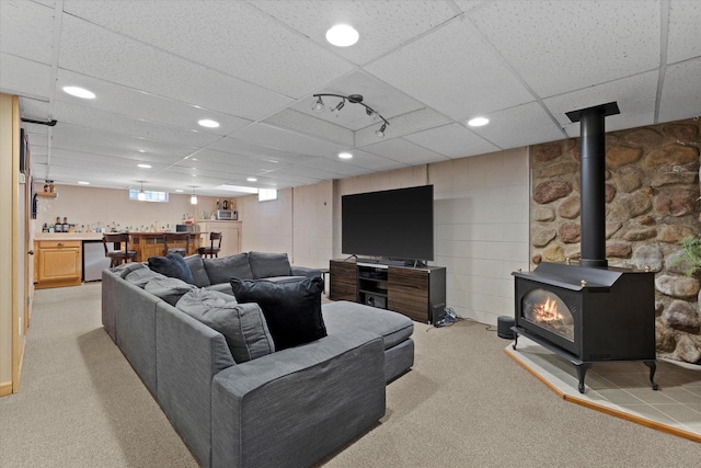 6196 N River Trail Dr, Milwaukee, WI 53225 - living area with light carpet, bar with sink, a drop ceiling, a wood stove, and recessed lighting