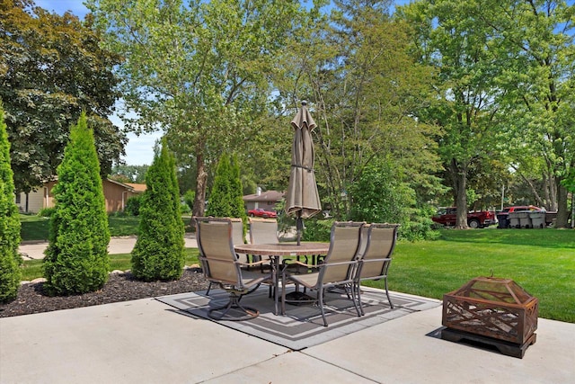 6196 N River Trail Dr, Milwaukee, WI 53225 - view of patio / terrace with a fire pit, outdoor dining space, and view of scattered trees