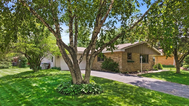 6196 N River Trail Dr, Milwaukee, WI 53225 - single story home featuring driveway, stone siding, a garage, and a front yard