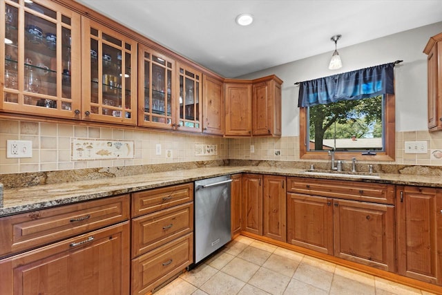 6196 N River Trail Dr, Milwaukee, WI 53225 - kitchen with stainless steel dishwasher, light tile patterned flooring, glass insert cabinets, and light stone countertops
