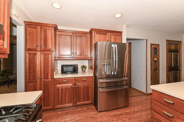 10500 W Good Hope Rd, Milwaukee, WI 53224 - kitchen featuring stainless steel fridge with ice dispenser, gas stove, light countertops, dark wood-style floors, and recessed lighting