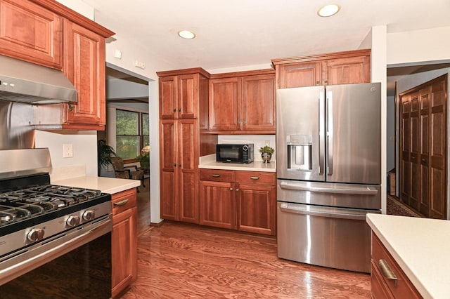 10500 W Good Hope Rd, Milwaukee, WI 53224 - kitchen with appliances with stainless steel finishes, light countertops, recessed lighting, wood finished floors, and under cabinet range hood