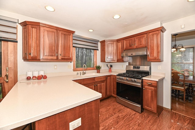10500 W Good Hope Rd, Milwaukee, WI 53224 - kitchen featuring under cabinet range hood, stainless steel gas range oven, light countertops, wood finished floors, and recessed lighting