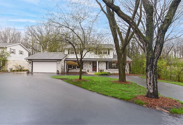 10500 W Good Hope Rd, Milwaukee, WI 53224 - traditional-style house featuring asphalt driveway, an attached garage, a front lawn, and brick siding