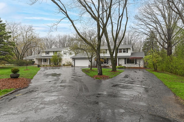 10500 W Good Hope Rd, Milwaukee, WI 53224 - traditional-style house with stone siding, driveway, a front yard, covered porch, and a garage