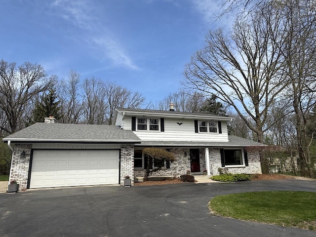 10500 W Good Hope Rd, Milwaukee, WI 53224 - traditional home featuring asphalt driveway, a garage, a porch, a chimney, and brick siding