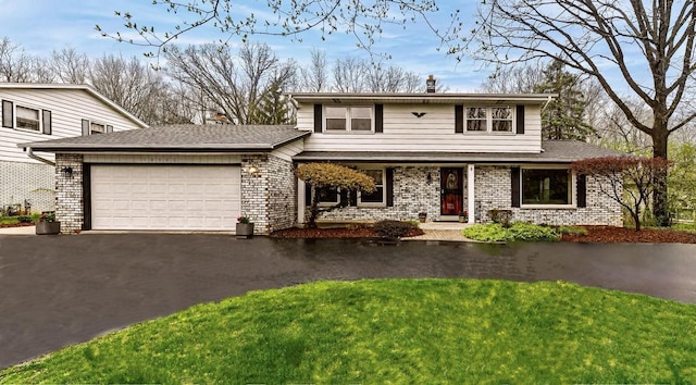 10500 W Good Hope Rd, Milwaukee, WI 53224 - traditional home with an attached garage, asphalt driveway, a chimney, a porch, and brick siding