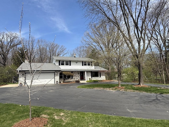 10500 W Good Hope Rd, Milwaukee, WI 53224 - view of front of property with an attached garage, a porch, asphalt driveway, and a chimney