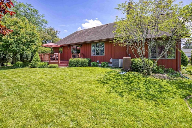 1334 W Cloverdale Dr, Appleton, WI 54914 - rear view of house with a deck, a lawn, roof with shingles, and board and batten siding