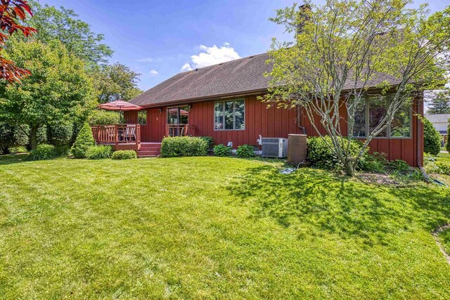 1334 W Cloverdale Dr, Appleton, WI 54914 - rear view of house with a deck, a lawn, roof with shingles, and board and batten siding