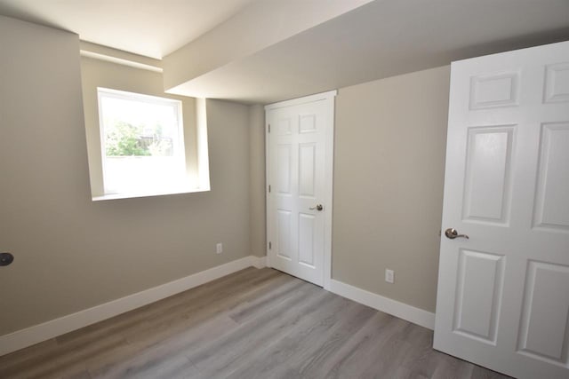 120 Eleonor St, Two Rivers, WI 54241 - unfurnished bedroom featuring baseboards and wood finished floors