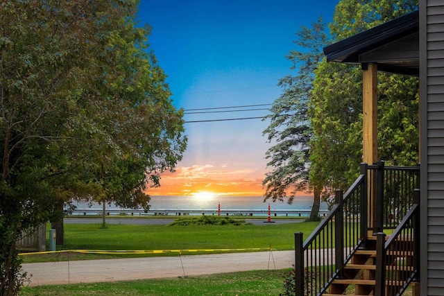 120 Eleonor St, Two Rivers, WI 54241 - yard at dusk with a water view, a yard, and stairs