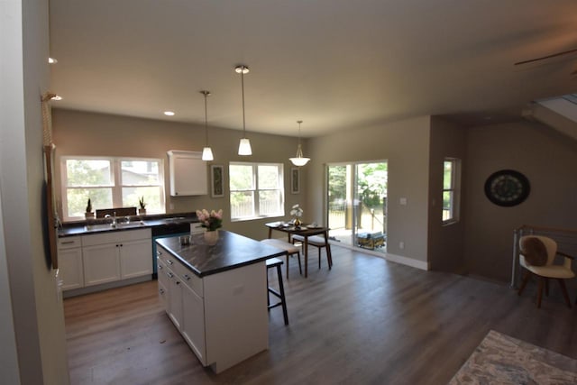 120 Eleonor St, Two Rivers, WI 54241 - kitchen featuring dark countertops, wood finished floors, white cabinetry, recessed lighting, and a kitchen island