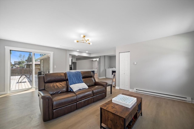 7705 241st Ave, Salem, WI 53168 - living area featuring baseboard heating, washer / clothes dryer, wood finished floors, and a chandelier