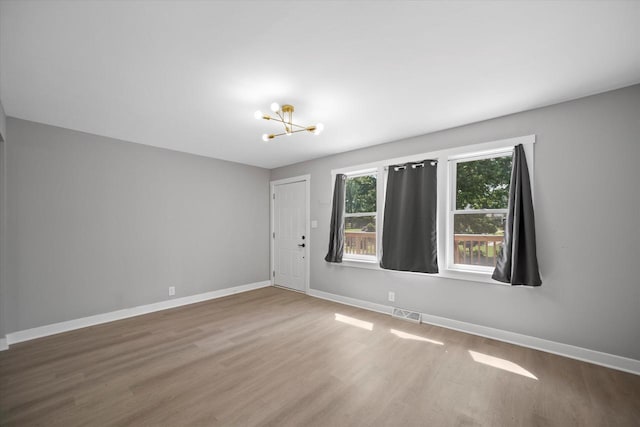7705 241st Ave, Salem, WI 53168 - spare room featuring a chandelier and wood finished floors