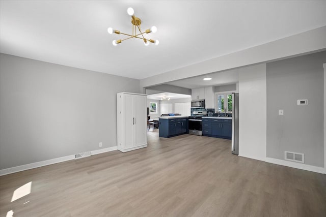 7705 241st Ave, Salem, WI 53168 - unfurnished living room featuring a chandelier and light wood-style floors