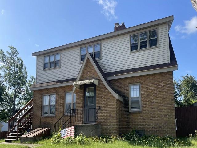 427 N 5th St, Tomahawk, WI 54487 - view of front of house with brick siding and a chimney