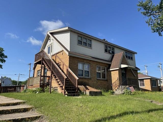 427 N 5th St, Tomahawk, WI 54487 - back of house with brick siding, stairs, and a deck