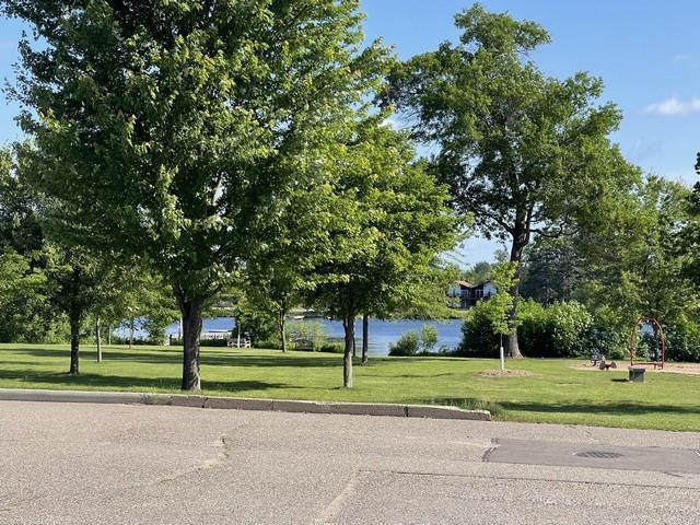 427 N 5th St, Tomahawk, WI 54487 - view of community featuring a lawn and a water view
