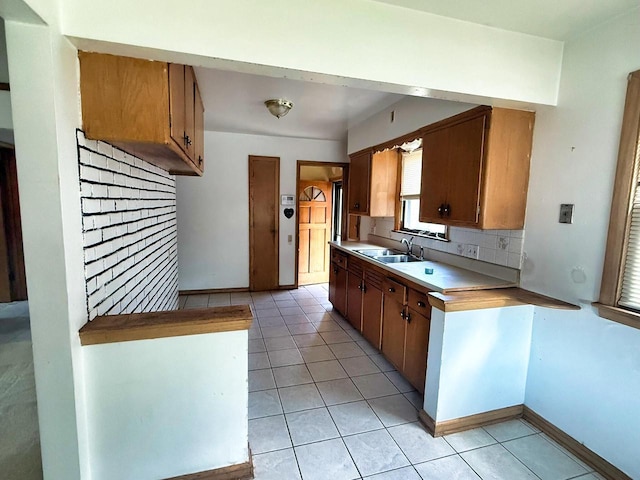 6352 W Medford Ave, Milwaukee, WI 53218 - kitchen featuring brown cabinets, light tile patterned floors, light countertops, and tasteful backsplash