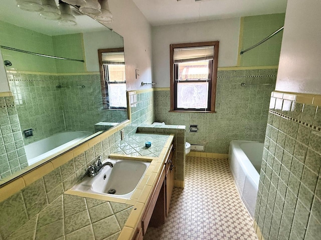 6352 W Medford Ave, Milwaukee, WI 53218 - bathroom with tile walls, tiled shower / bath combo, vanity, and a wainscoted wall