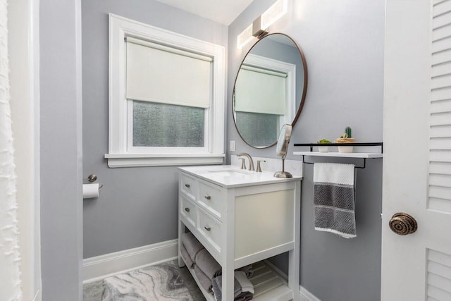 814 E Irving Ave, Oshkosh, WI 54901 - bathroom featuring baseboards and vanity