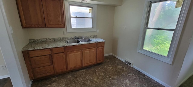 4652 N 49th St, Milwaukee, WI 53218 - kitchen featuring healthy amount of natural light and brown cabinets