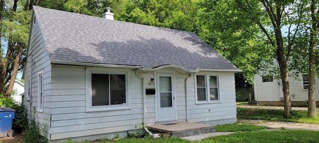 4652 N 49th St, Milwaukee, WI 53218 - view of front of house with a shingled roof and a chimney