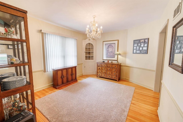 2278 S Riverside Dr, Beloit, WI 53511 - living area featuring a chandelier and light wood-style flooring