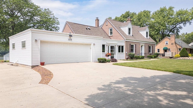 2278 S Riverside Dr, Beloit, WI 53511 - new england style home with a garage, driveway, and a front yard