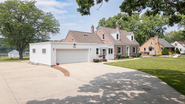 2278 S Riverside Dr, Beloit, WI 53511 - cape cod house with driveway, a front lawn, an attached garage, and a chimney