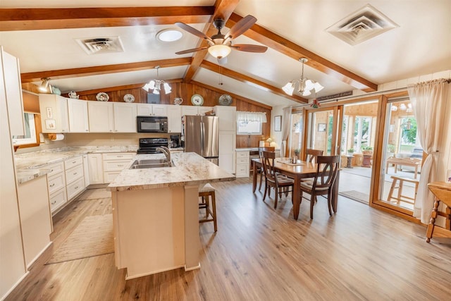 2278 S Riverside Dr, Beloit, WI 53511 - kitchen with black appliances, ceiling fan, a chandelier, light wood-type flooring, and a center island with sink