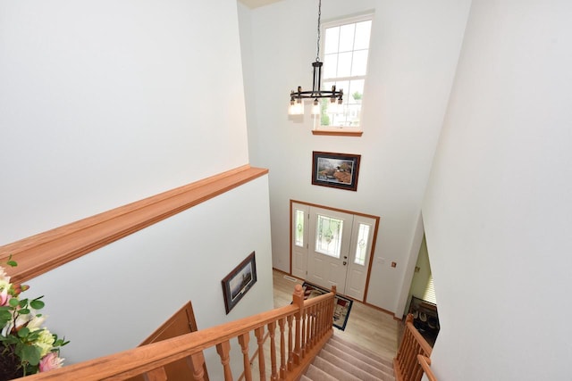 847 Chisholm Ln, Port Washington, WI 53074 - entryway featuring a chandelier, a high ceiling, light wood finished floors, and stairway