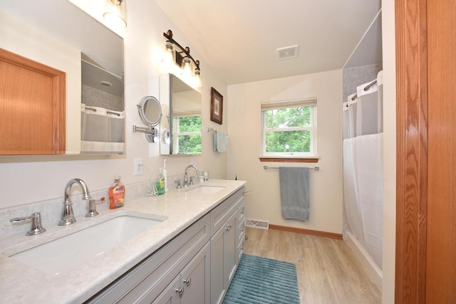 847 Chisholm Ln, Port Washington, WI 53074 - full bath featuring wood finished floors, double vanity, and a shower with shower curtain