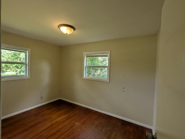 N51W14111 Lancaster Ave, Menomonee Falls, WI 53051 - unfurnished room featuring baseboards and dark wood-type flooring