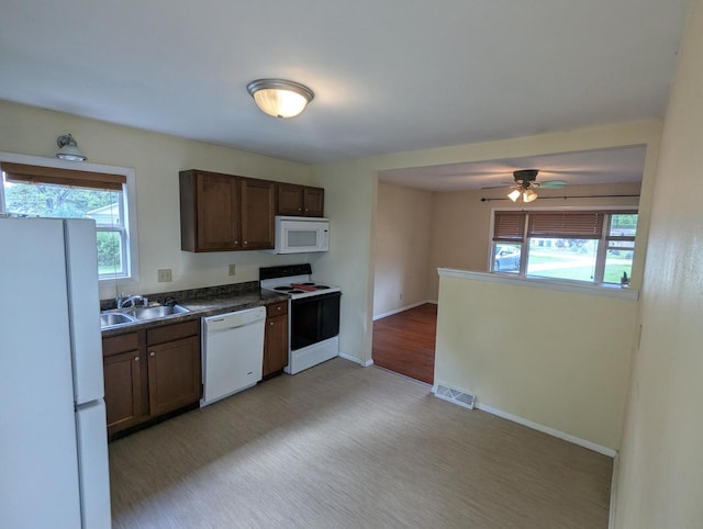 N51W14111 Lancaster Ave, Menomonee Falls, WI 53051 - kitchen with white appliances, healthy amount of natural light, ceiling fan, and dark countertops