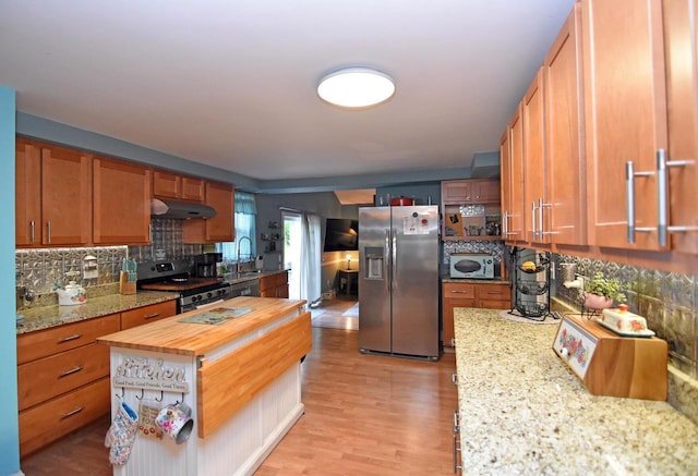 6401 237th Ave, Salem, WI 53168 - kitchen with appliances with stainless steel finishes, wood counters, decorative backsplash, under cabinet range hood, and light wood-style flooring