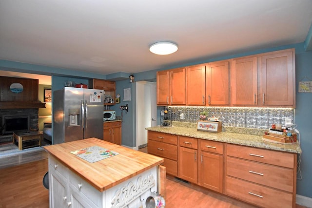 6401 237th Ave, Salem, WI 53168 - kitchen featuring stainless steel fridge, wooden counters, light wood-style flooring, decorative backsplash, and white microwave