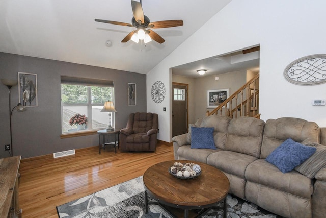 2335 Macarthur Rd, Waukesha, WI 53188 - living room featuring wood finished floors, ceiling fan, stairway, and high vaulted ceiling