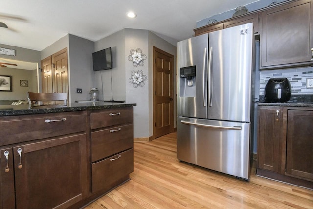 2335 Macarthur Rd, Waukesha, WI 53188 - kitchen featuring stainless steel fridge with ice dispenser, light wood-type flooring, dark stone counters, dark brown cabinets, and recessed lighting