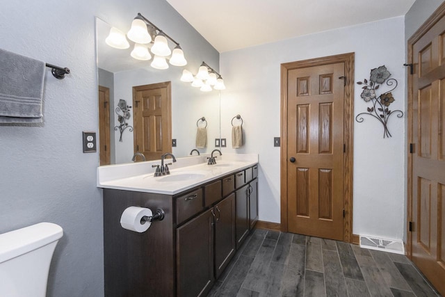 2335 Macarthur Rd, Waukesha, WI 53188 - bathroom with double vanity and wood finished floors