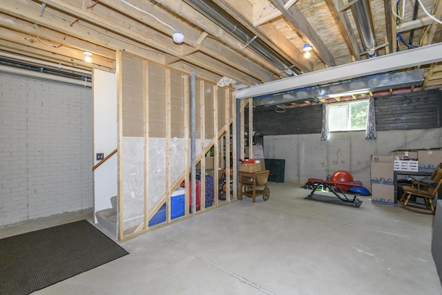 2335 Macarthur Rd, Waukesha, WI 53188 - below grade area with stairway and brick wall