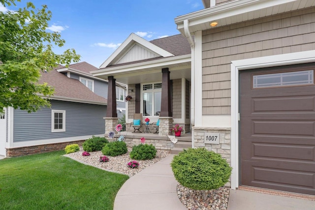 1007 Waterford Ln, Waunakee, WI 53597 - property entrance featuring covered porch, an attached garage, a lawn, stone siding, and roof with shingles