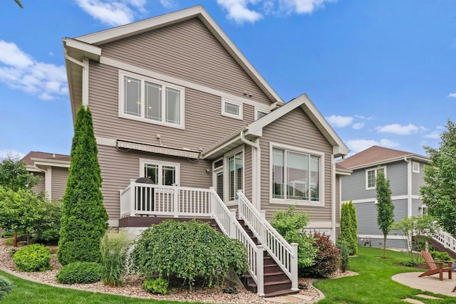 1007 Waterford Ln, Waunakee, WI 53597 - rear view of house featuring stairway, a yard, and a wooden deck